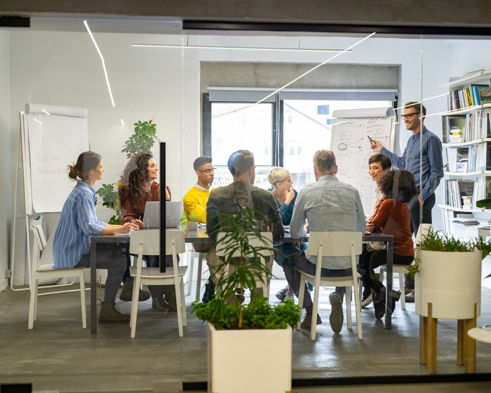 Public sector consulting team reviewing policy briefing in formal meeting room