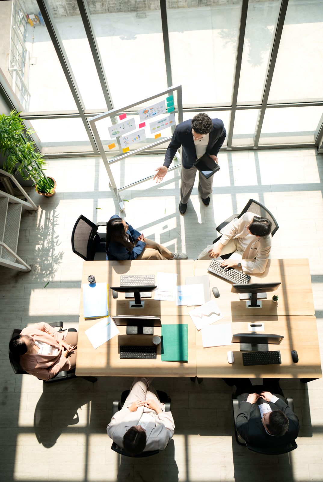 Overhead view of a professional team collaborating around a meeting table
